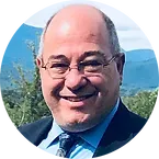 A man in a suit and tie is smiling in a circle.