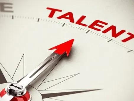 A compass with a red arrow pointing to the word talent