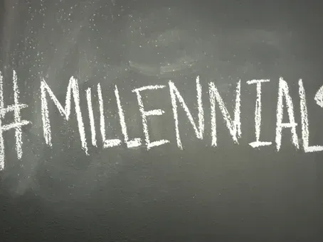 The word millennial is written in white chalk on a blackboard.