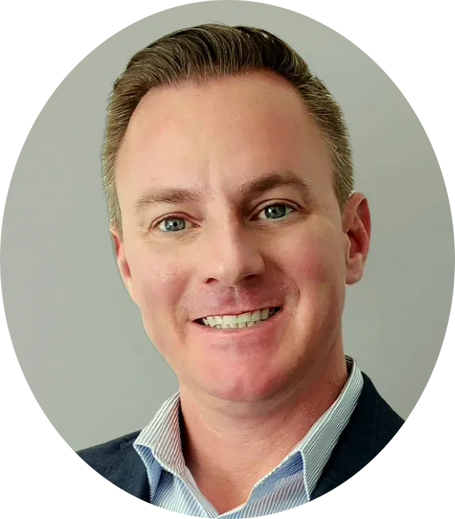 A man in a suit and striped shirt is smiling in a circle.