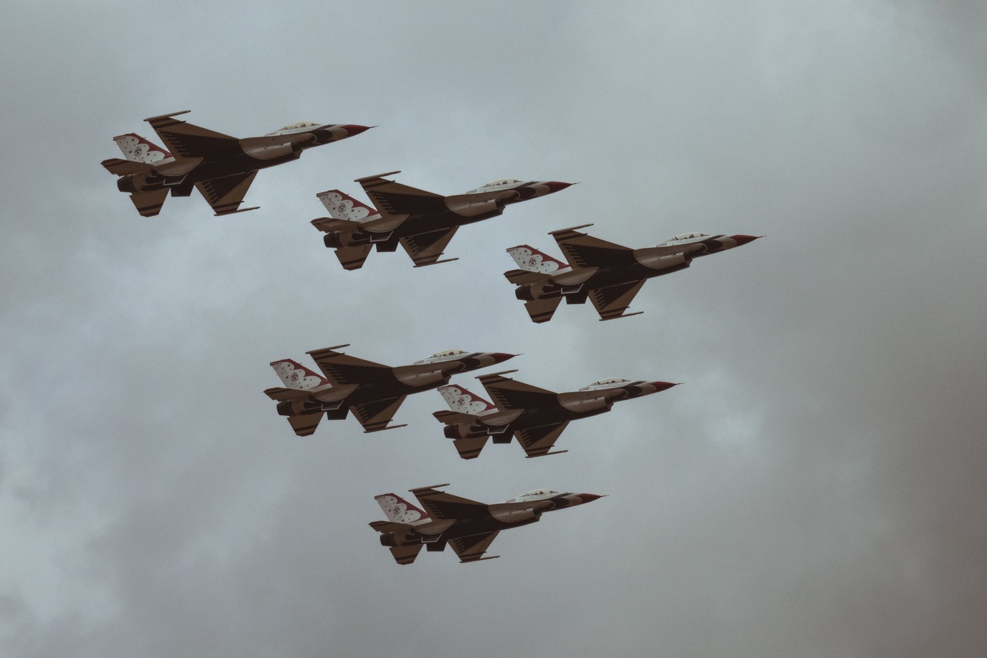 A group of fighter jets are flying in formation