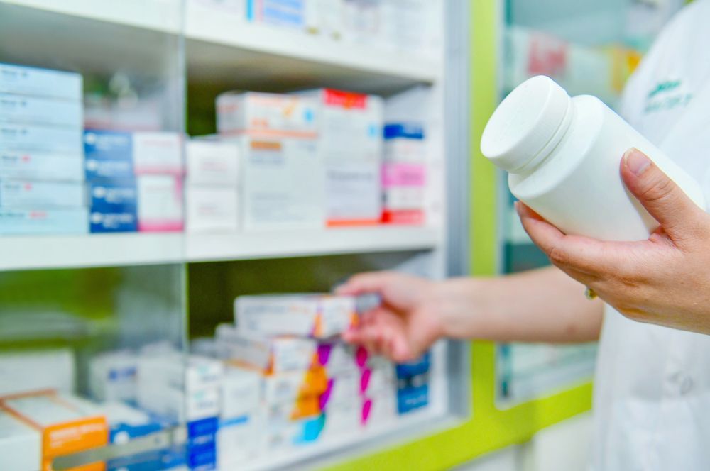 Pharmacist in a Pharmacy Selecting Medication — Blooms The Chemist Sawtell in Sawtell, NSW