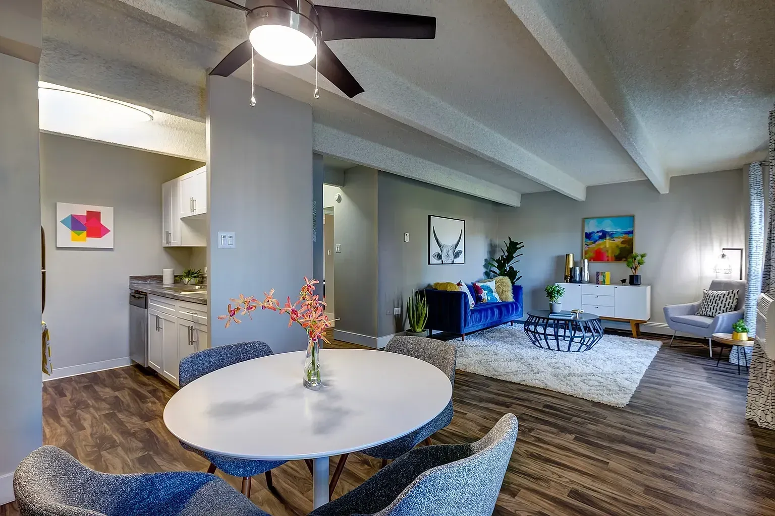 Open-concept living and dining area with a kitchen visible.