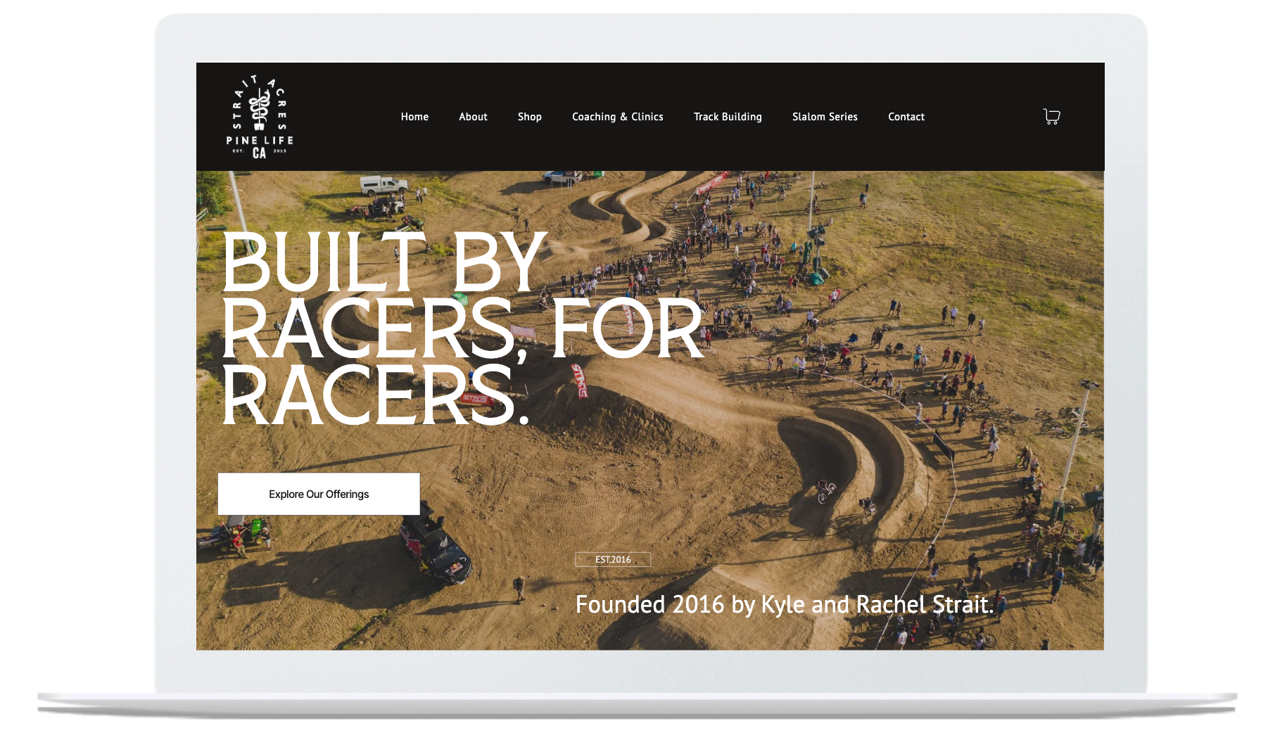 Laptop screen displaying a motocross track with text 