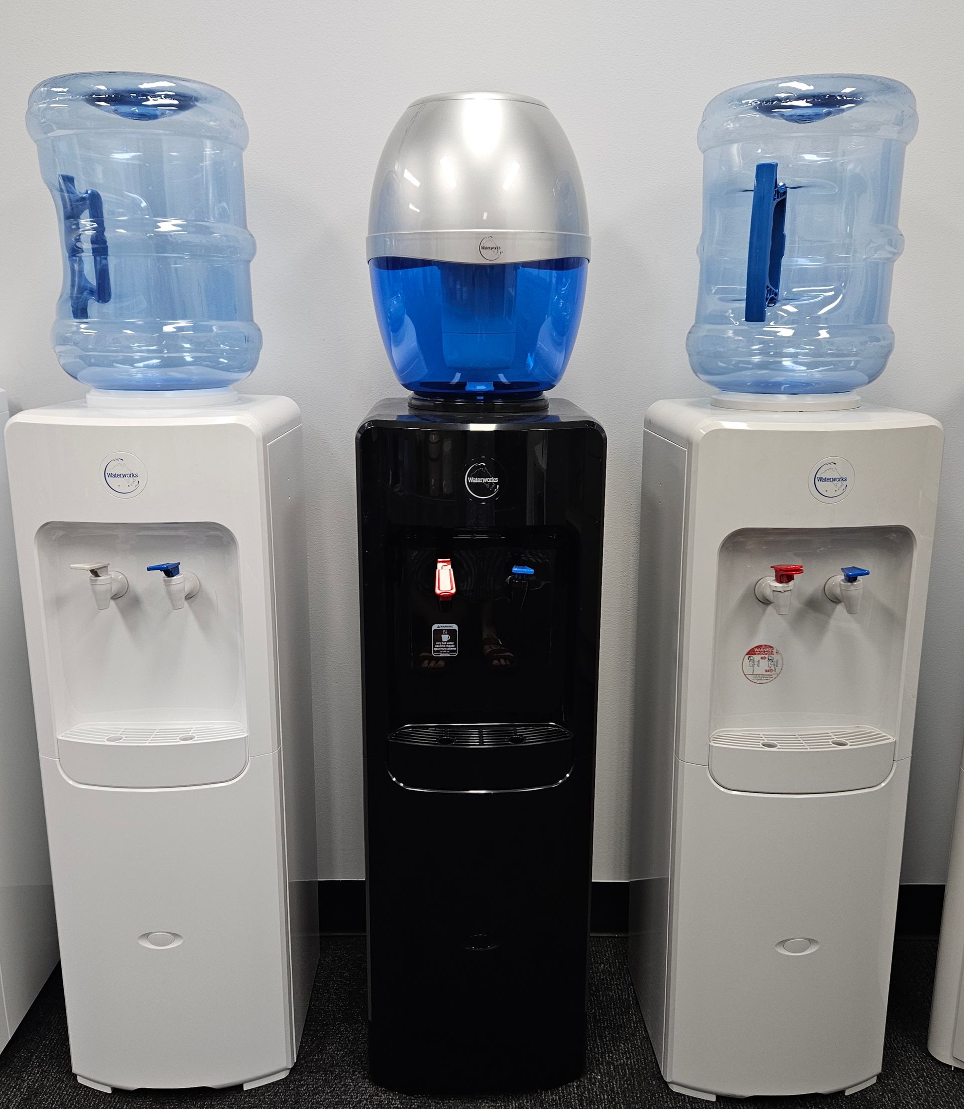 Three Water Dispensers Are Lined Up Next To Each Other — Billabong Springs in Jimboomba, QLD