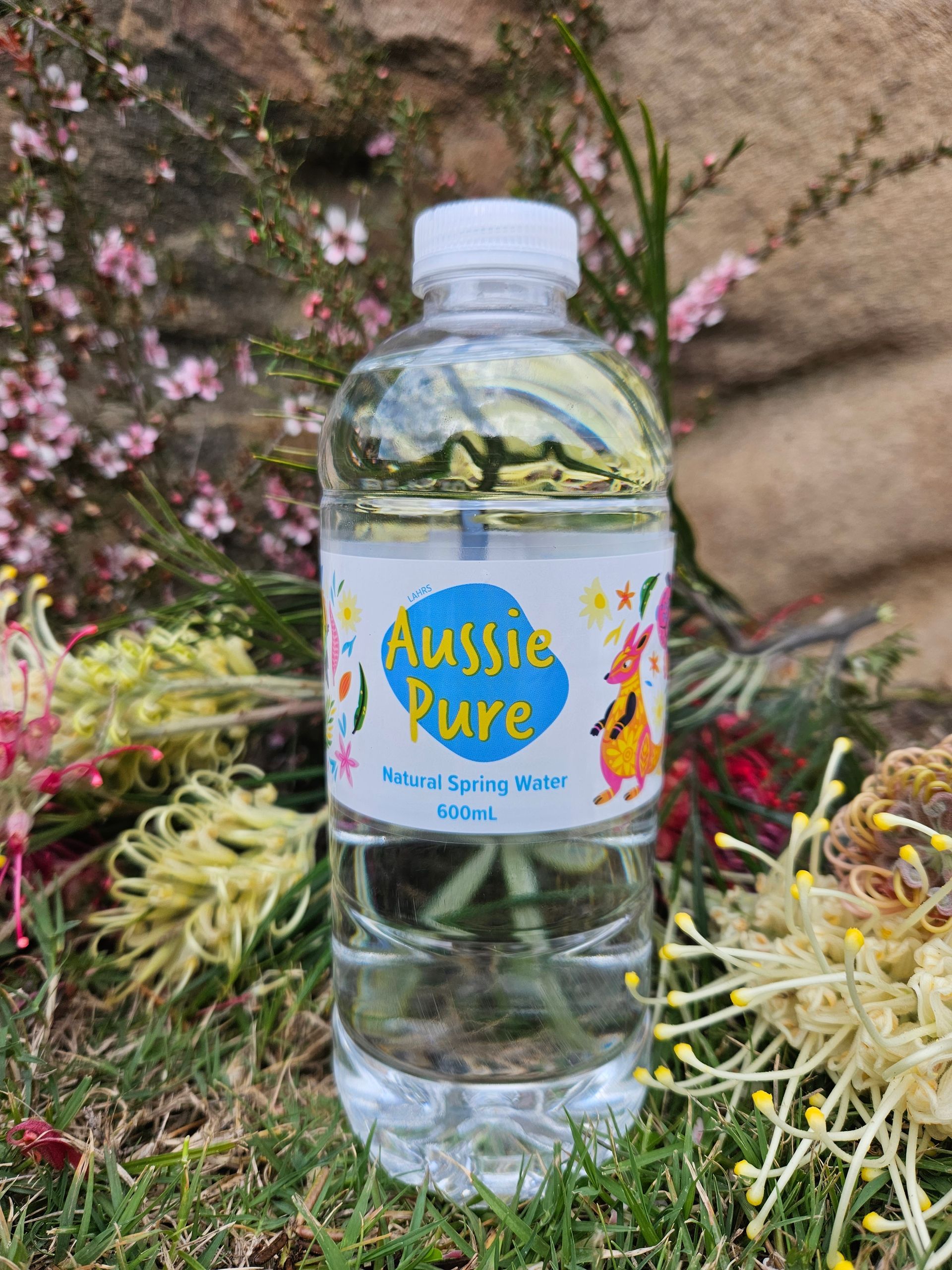 A Bottle Of Water Is Sitting On Top Of A Lush Green Field — Billabong Springs in Jimboomba, QLD