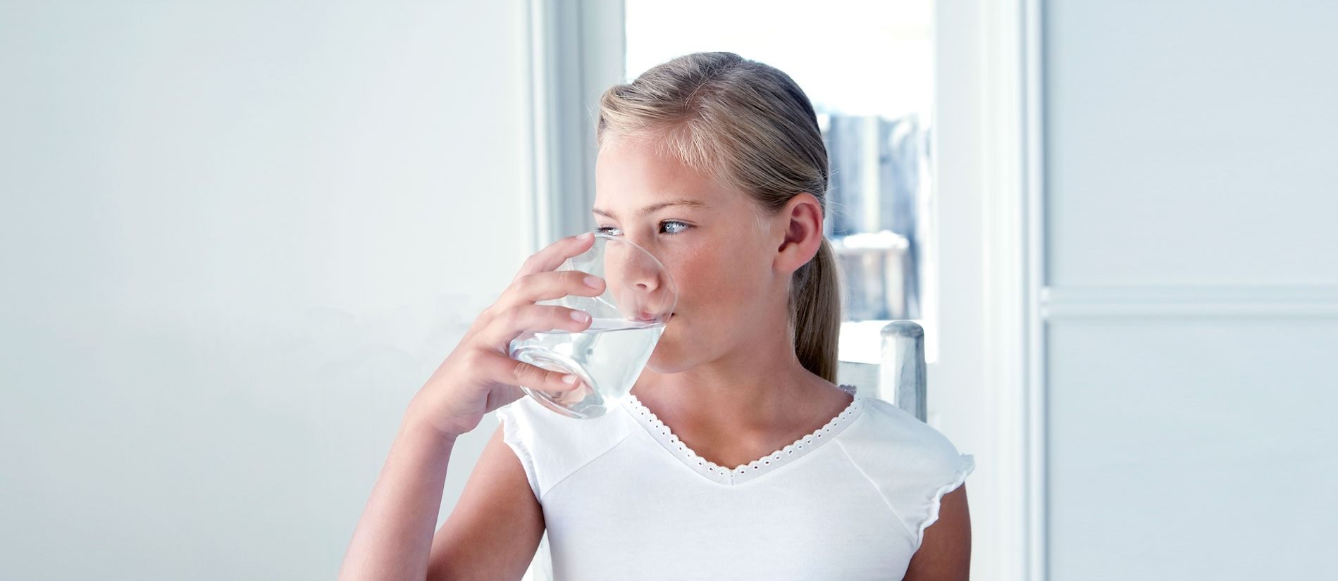 A Young Girl Is Drinking A Glass Of Water — Billabong Springs in Jimboomba, QLD