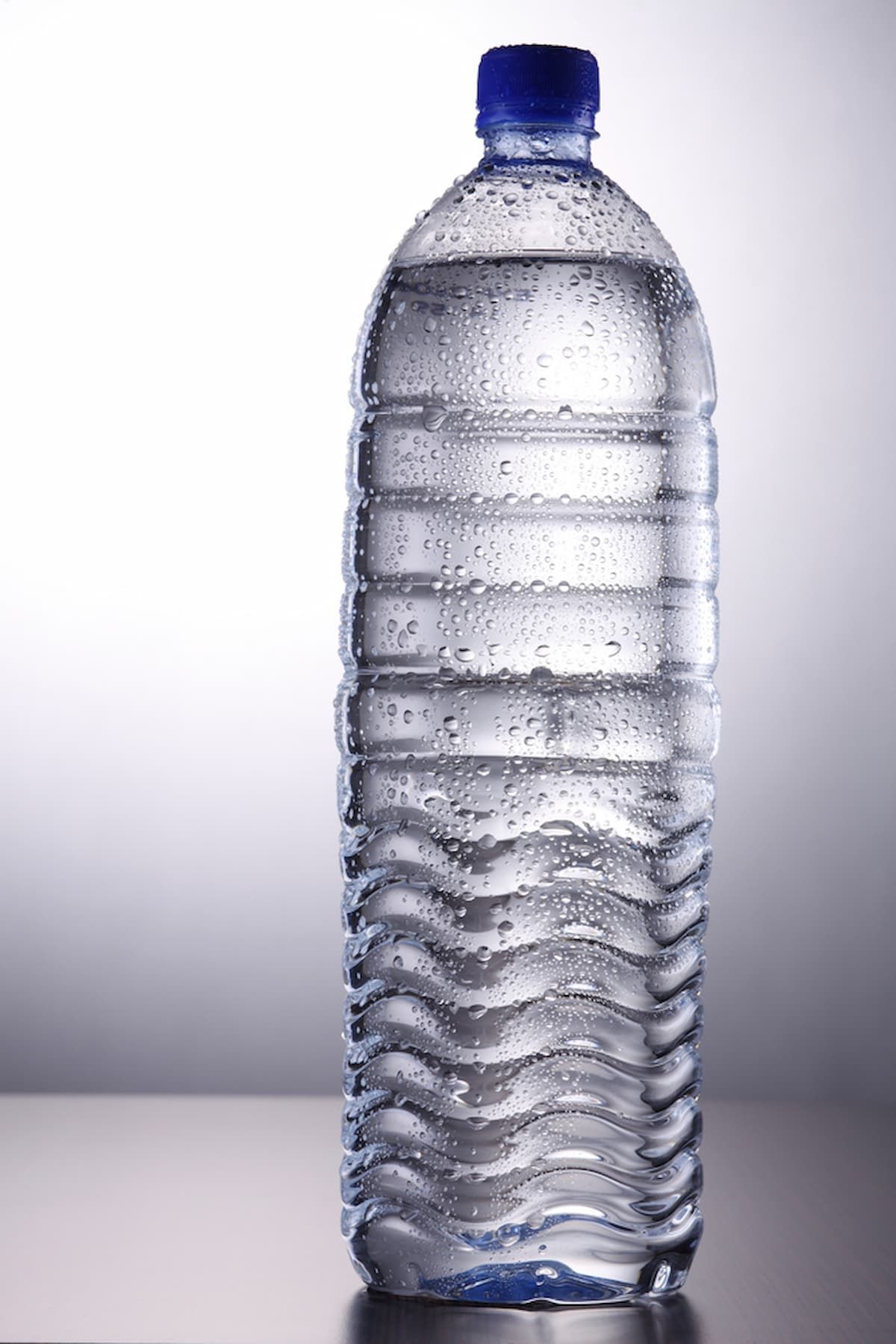 A Bottle of Water with A Blue Cap Is on A Table — Billabong Springs in Gold Coast, QLD