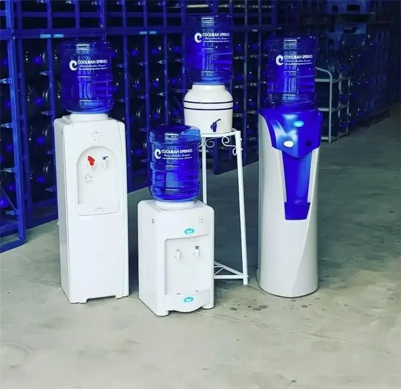 Three Water Coolers Are Lined up In a Warehouse — Billabong Springs in Gold Coast, QLD