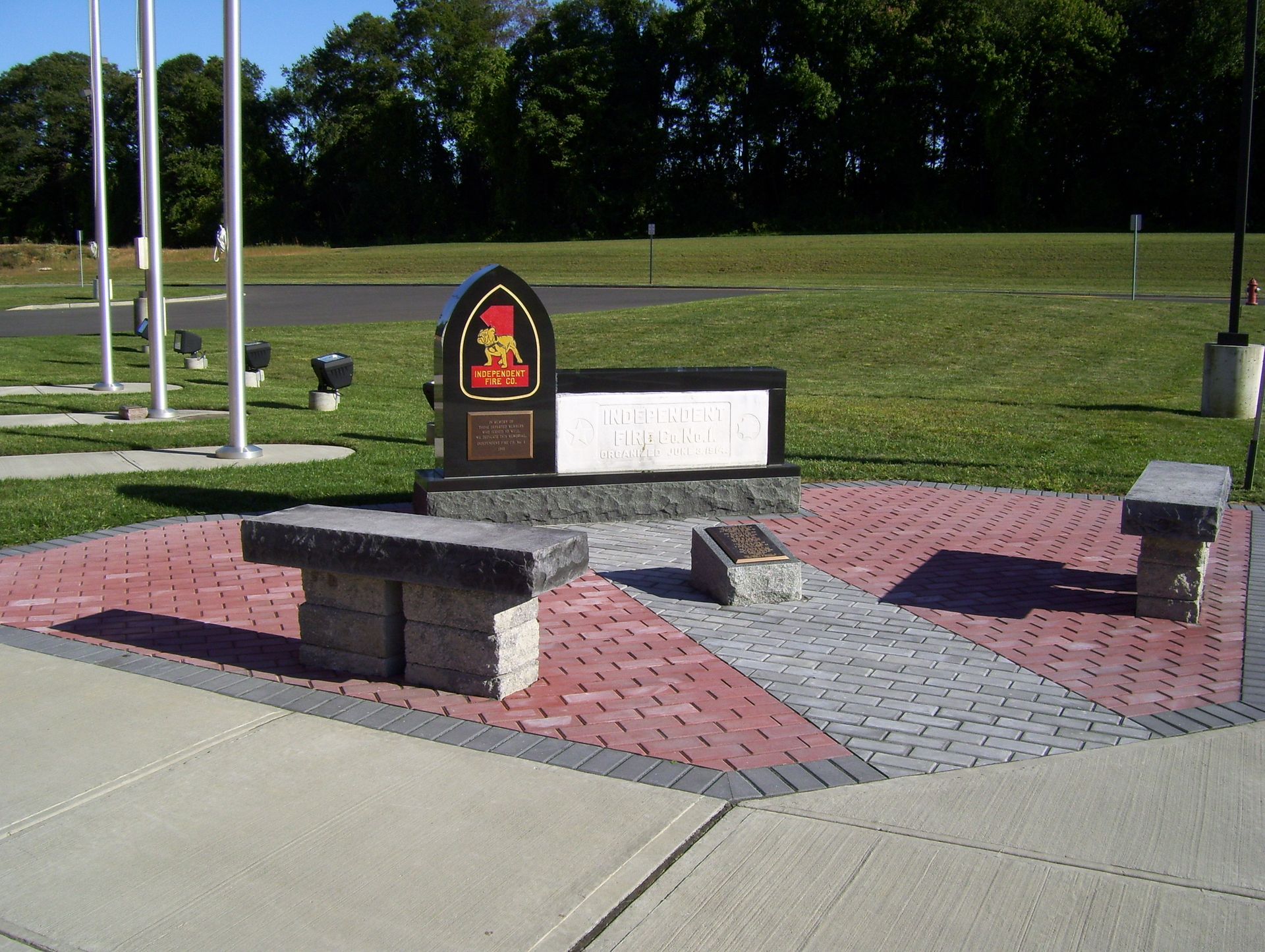 A memorial with a black stone marker displaying the