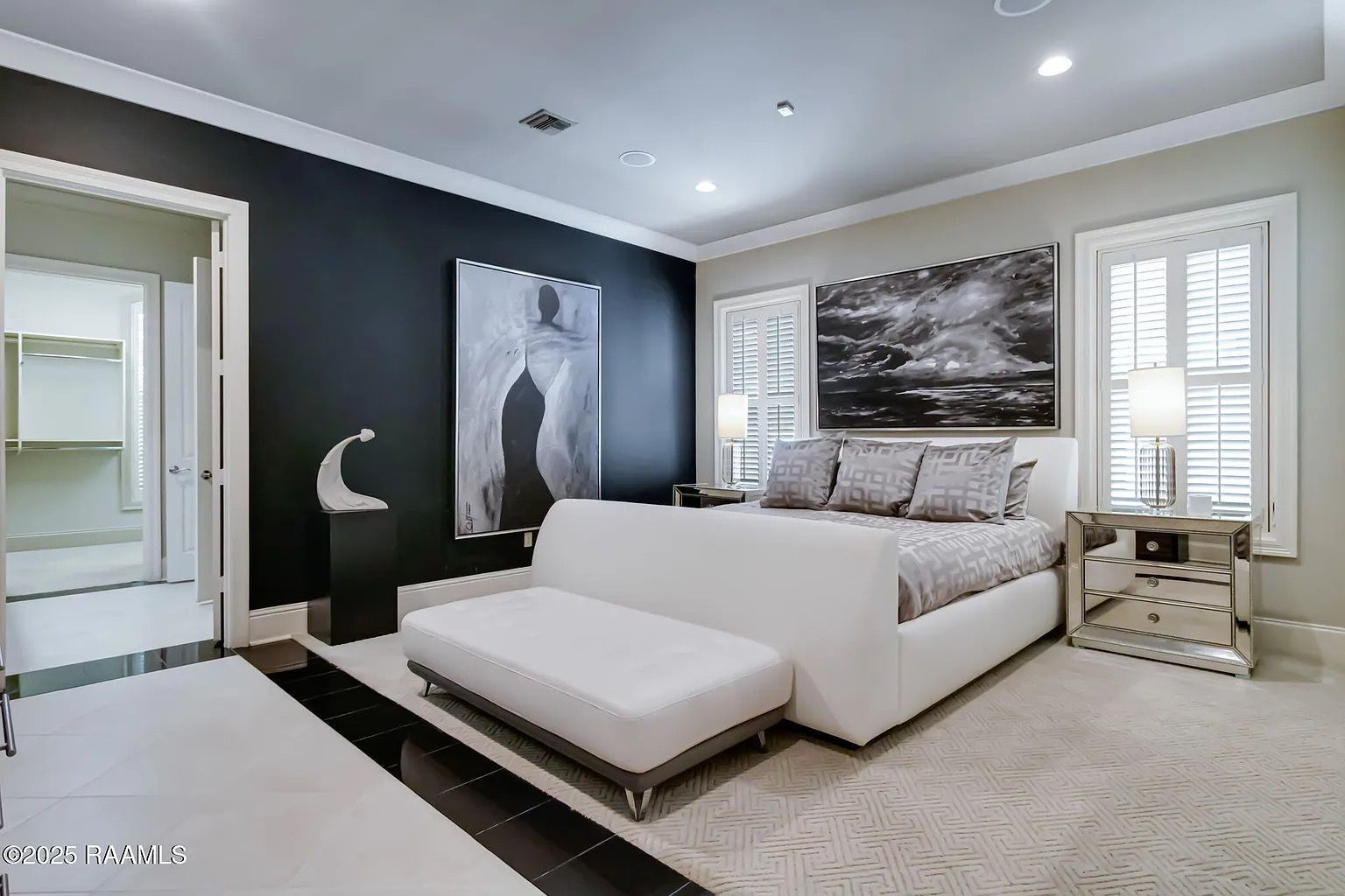 A bedroom with a large bed and a couch