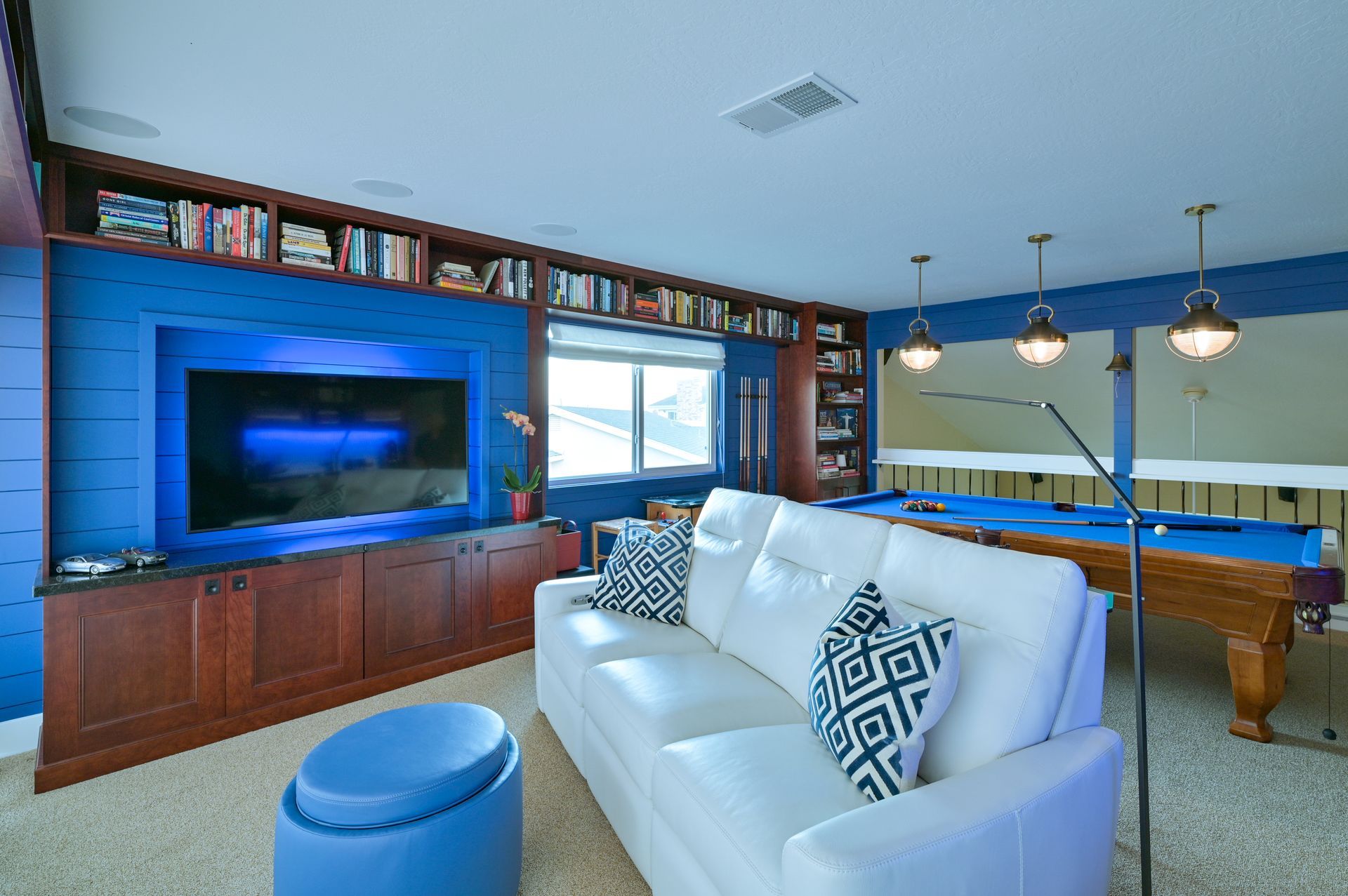 a living room with a pool table and a couch