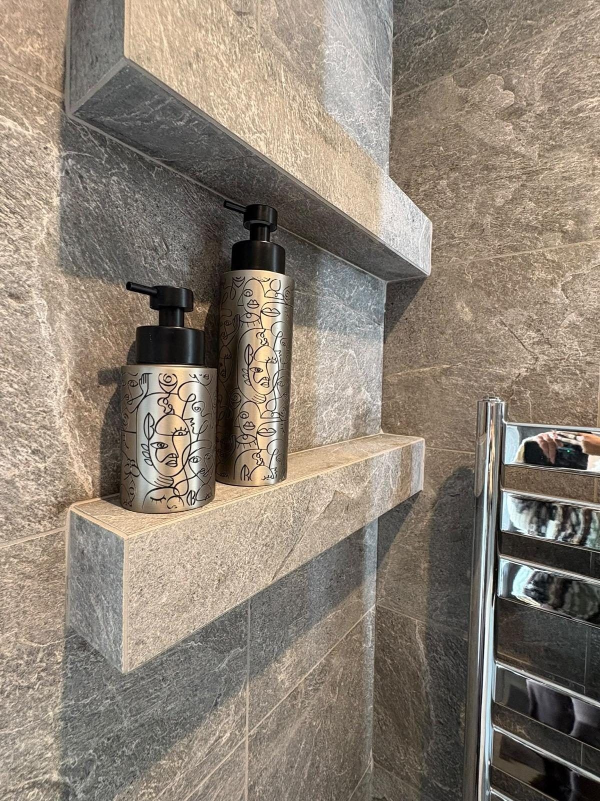 Shelves built into a bathroom wall and finished in slate-effect tile