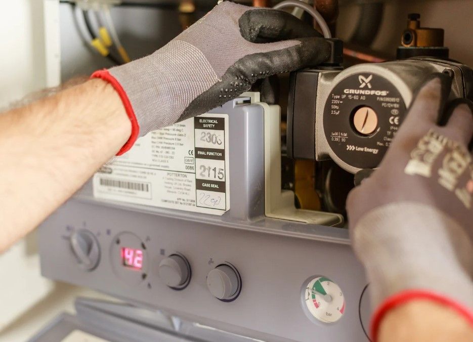 Derbyshire Plumbing & Heating Specialists carrying out and annual boiler service of a combi boiler in Derby