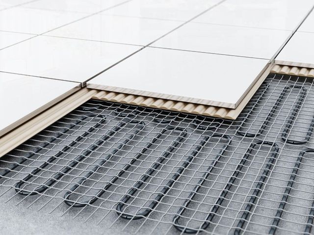 Underfloor heating laid beneath a tiled floor, shown in cross-section