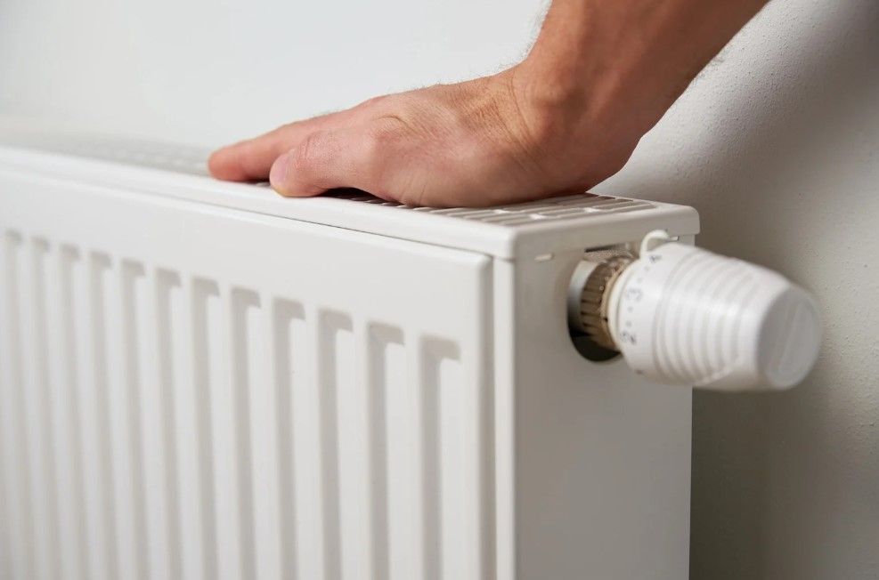 Derbyshire Plumbing & Heating Specialists checking a radiator following a power flush in Belper