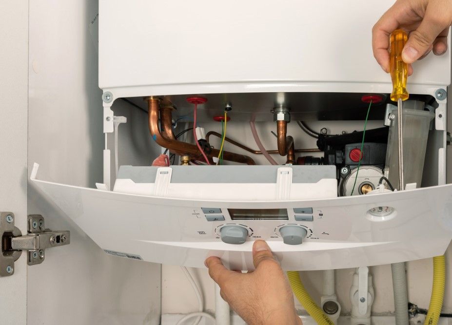 Derbyshire Plumbing & Heating Specialists performing an annual boiler service on a Worcester Bosch boiler in Derby