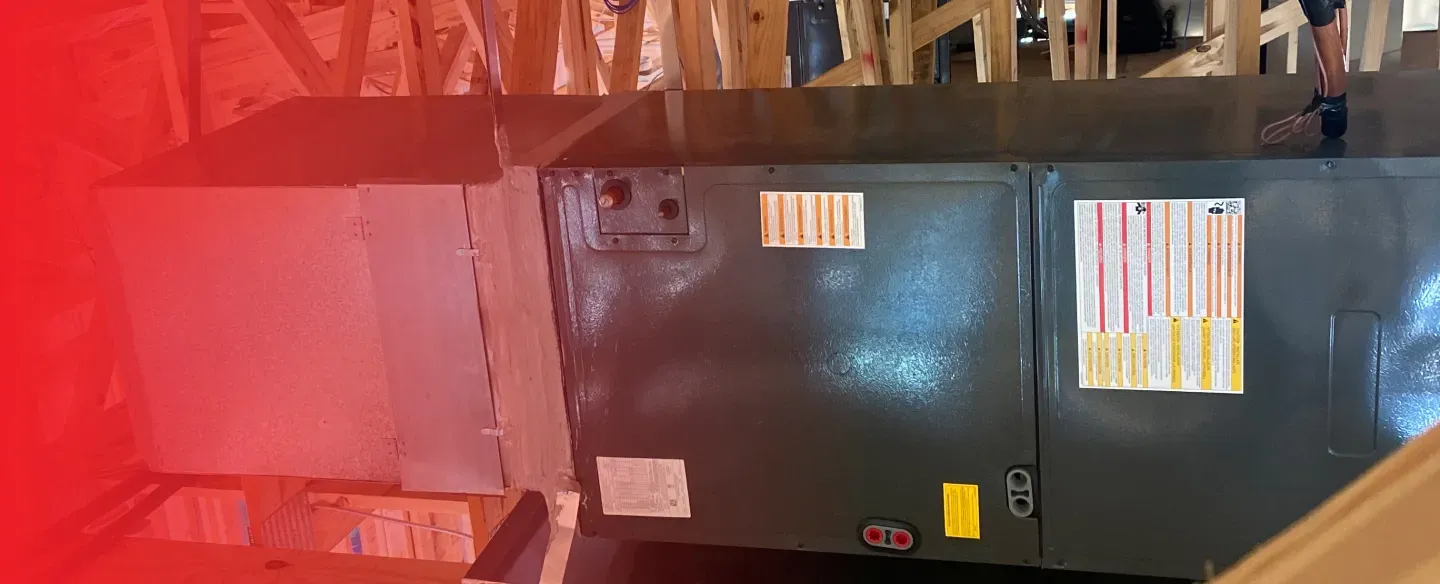 A black box is sitting in a room with a red background.