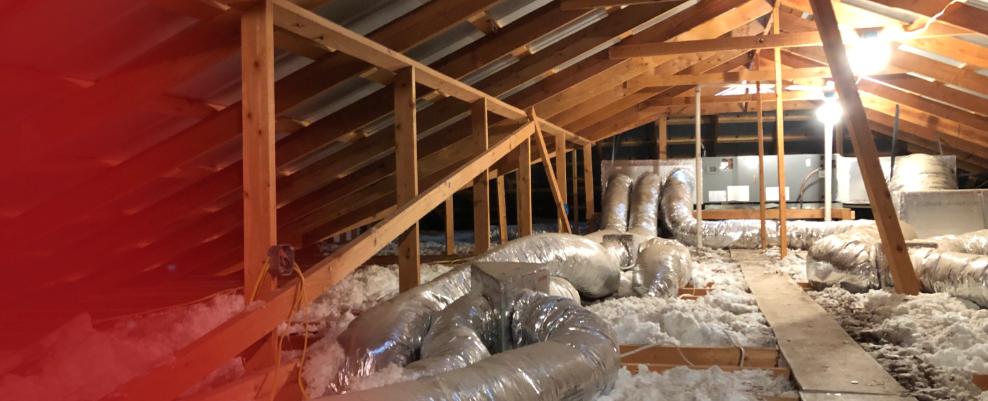 There is a lot of insulation in the attic of a house.