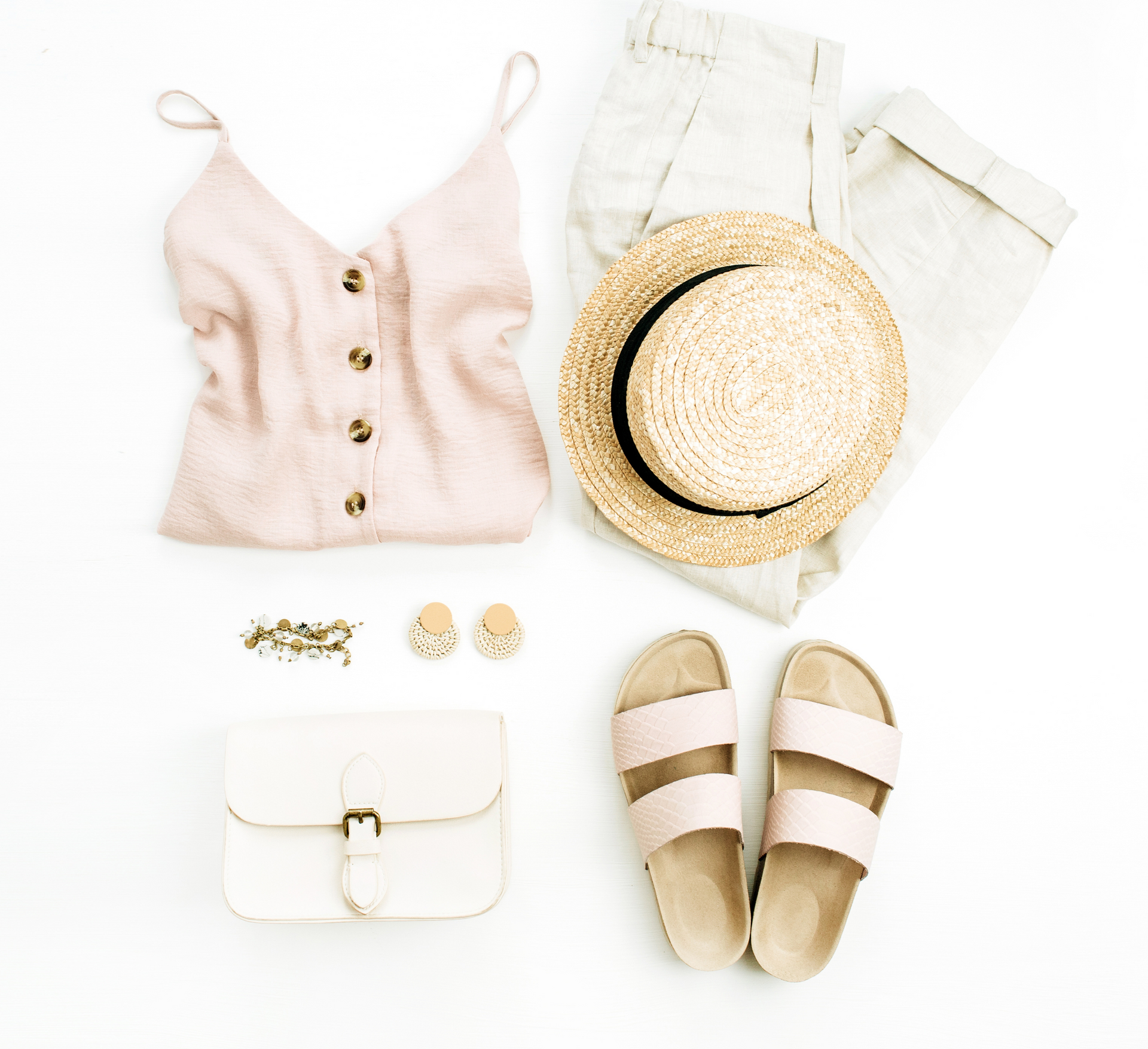 outfit laid out, including shirt, pants, shoes, accessories, white purse and straw hat