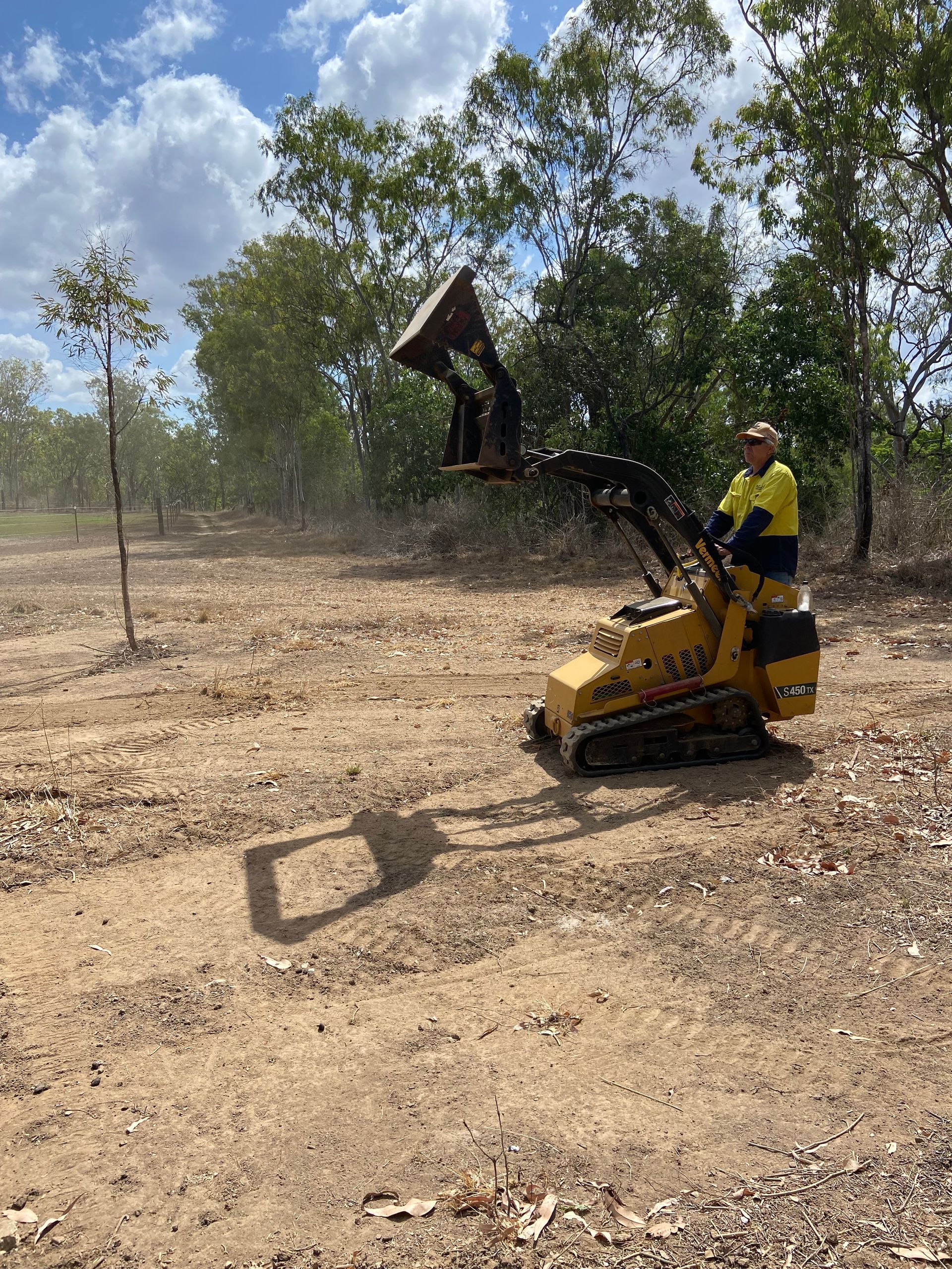 Mini Excavator Lifting Debris — RCJJ Mini Loaders In Cairns, QLD