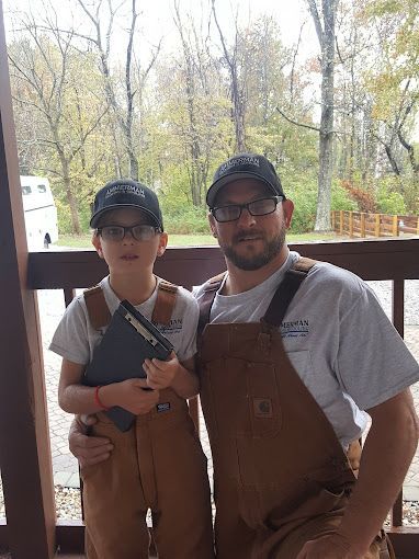 A man and a boy are posing for a picture on a porch.