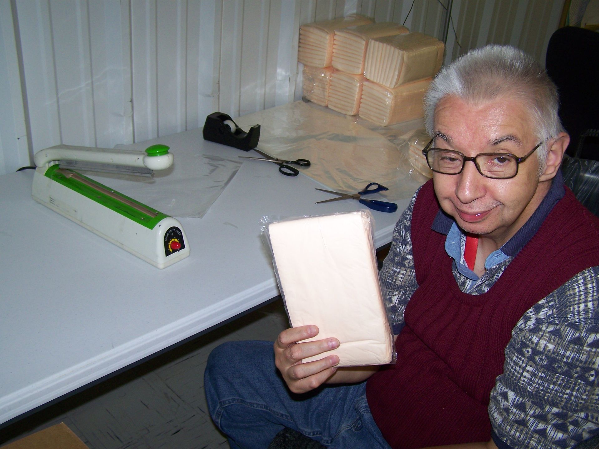 A man is sitting at a table holding a piece of paper