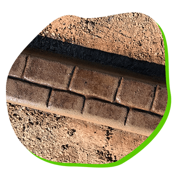 A close up of a brick wall with a green border