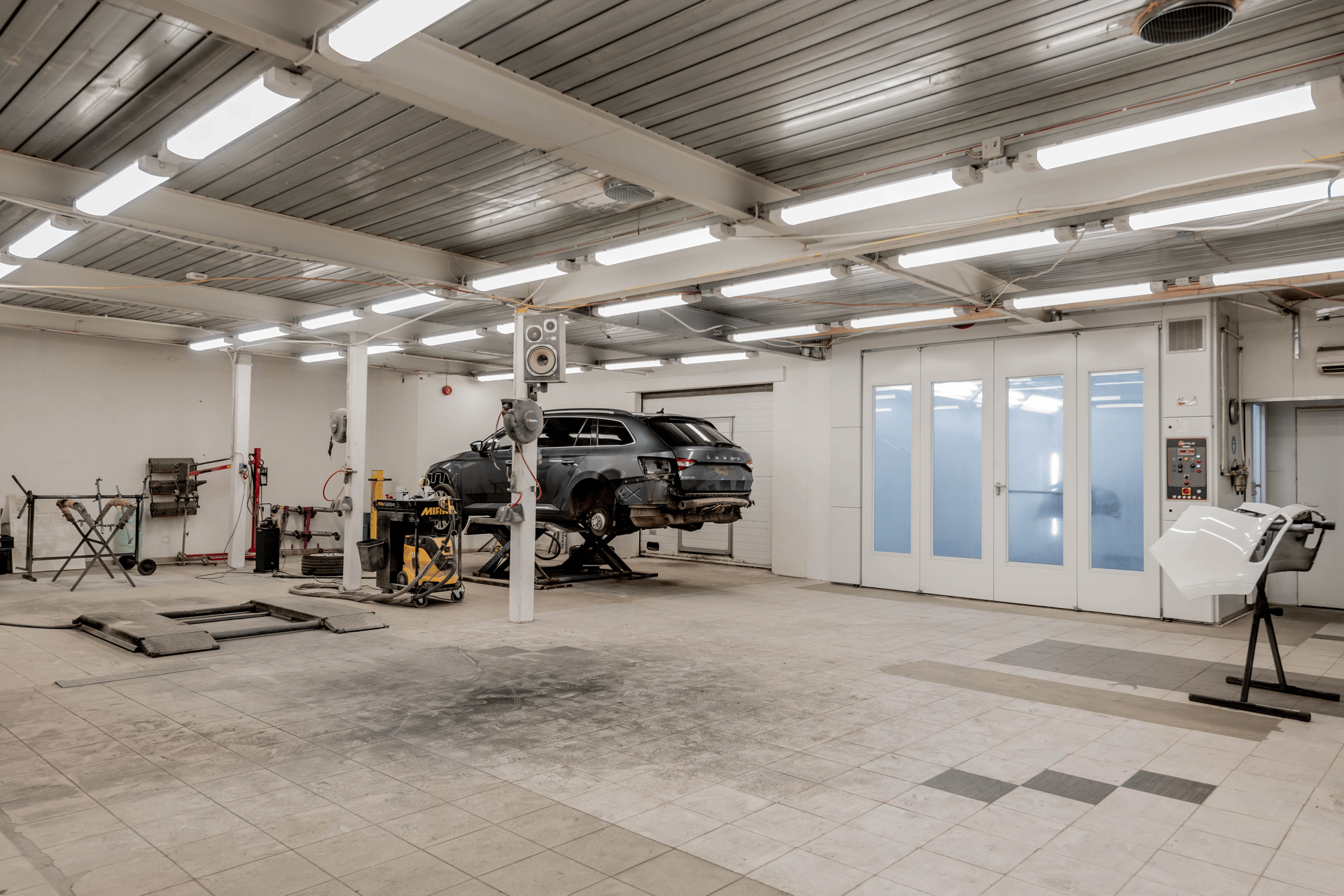 A professional auto repair shop interior with service bays and vehicle lifts