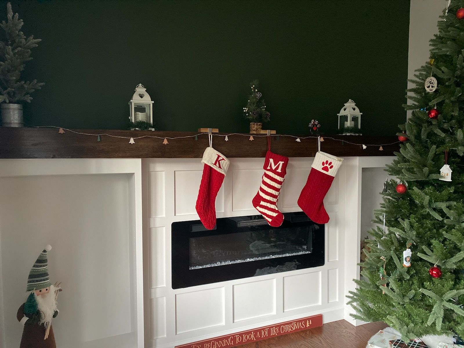 Christmas fireplace with stockings, tree, and decorations.