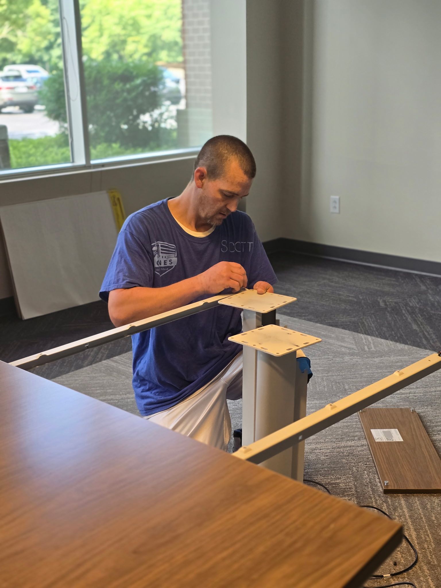 Scott expertly and precisely taking apart a conference table to be professionally and safely moved to a new office.