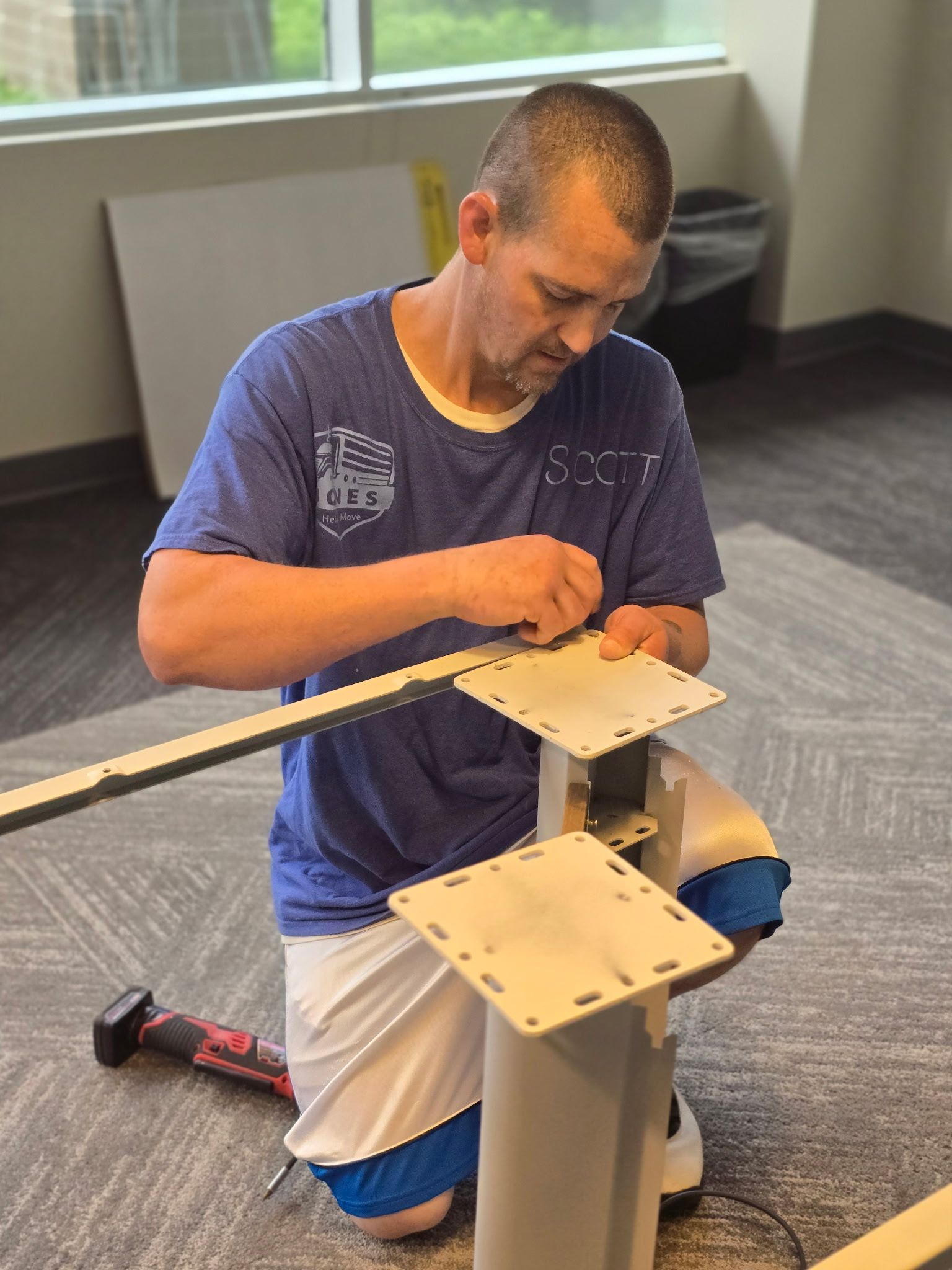 JHUM team member Scott disassembling a conference table during a professional commercial office move in Cary, NC. 