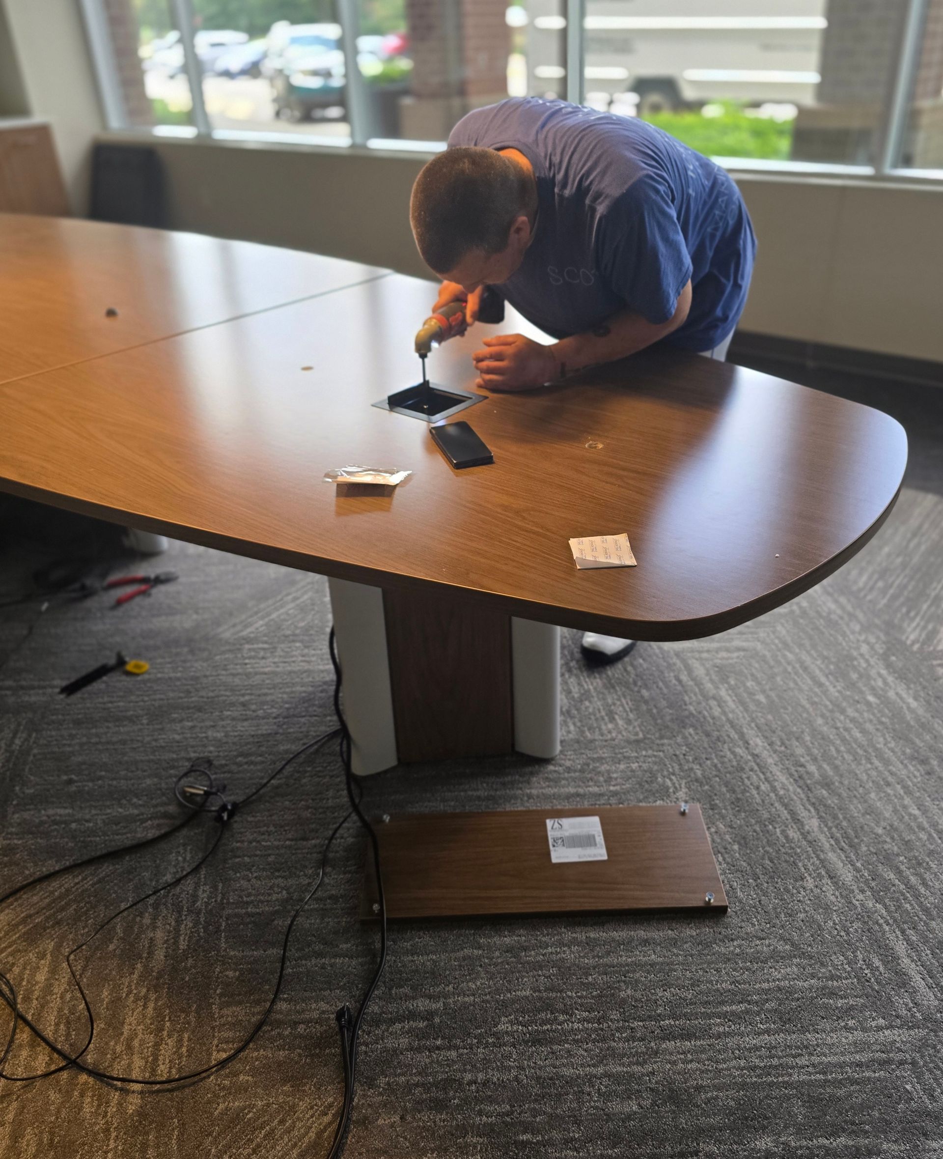 Jones Helps U Move crew member assembling office furniture during a commercial move