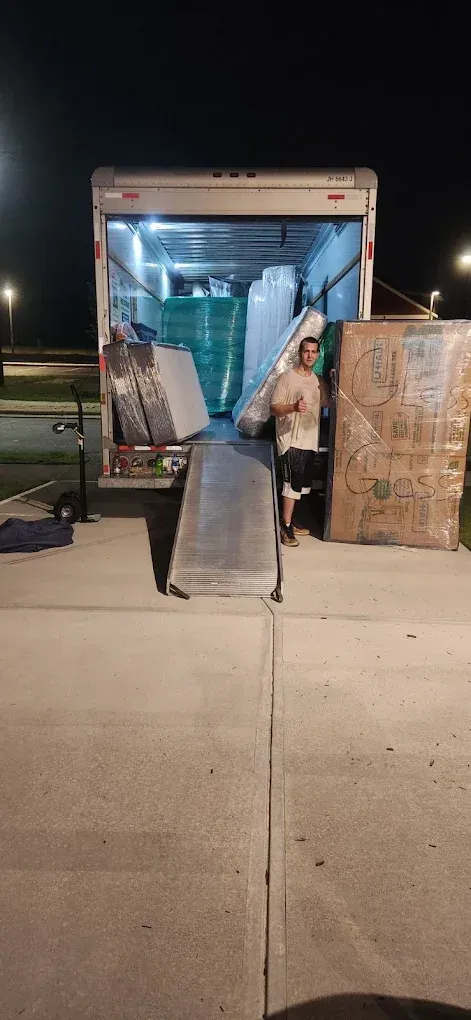 Moving truck expertly loaded for safe transport of residential furniture in Holly Springs, NC.