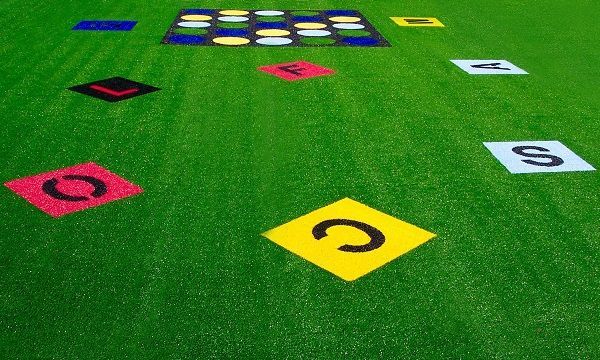 Colored number cards scattered on green carpet, with a grid of cards near the top.