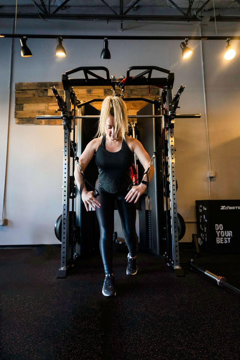 Superset Fitness client using cable machine.