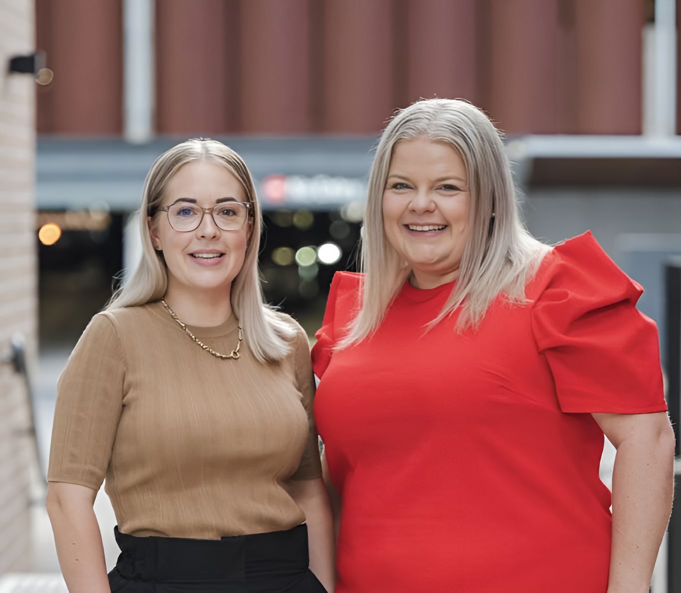 Two Women Are Posing For A Picture Together And One Is Wearing A Red Shirt — Grant Finance Solutions In Toowoomba, QLD