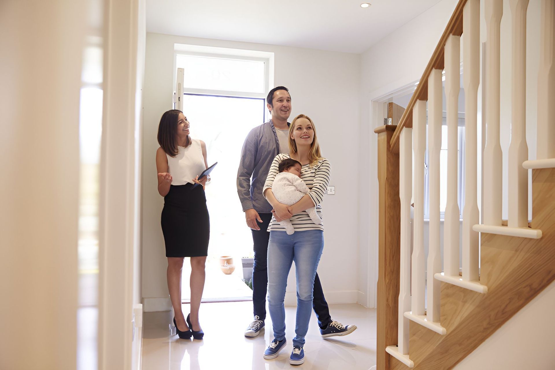 A Family Is Looking At Their New Home With A Real Estate Agent — Grant Finance Solutions In Toowoomba, QLD
