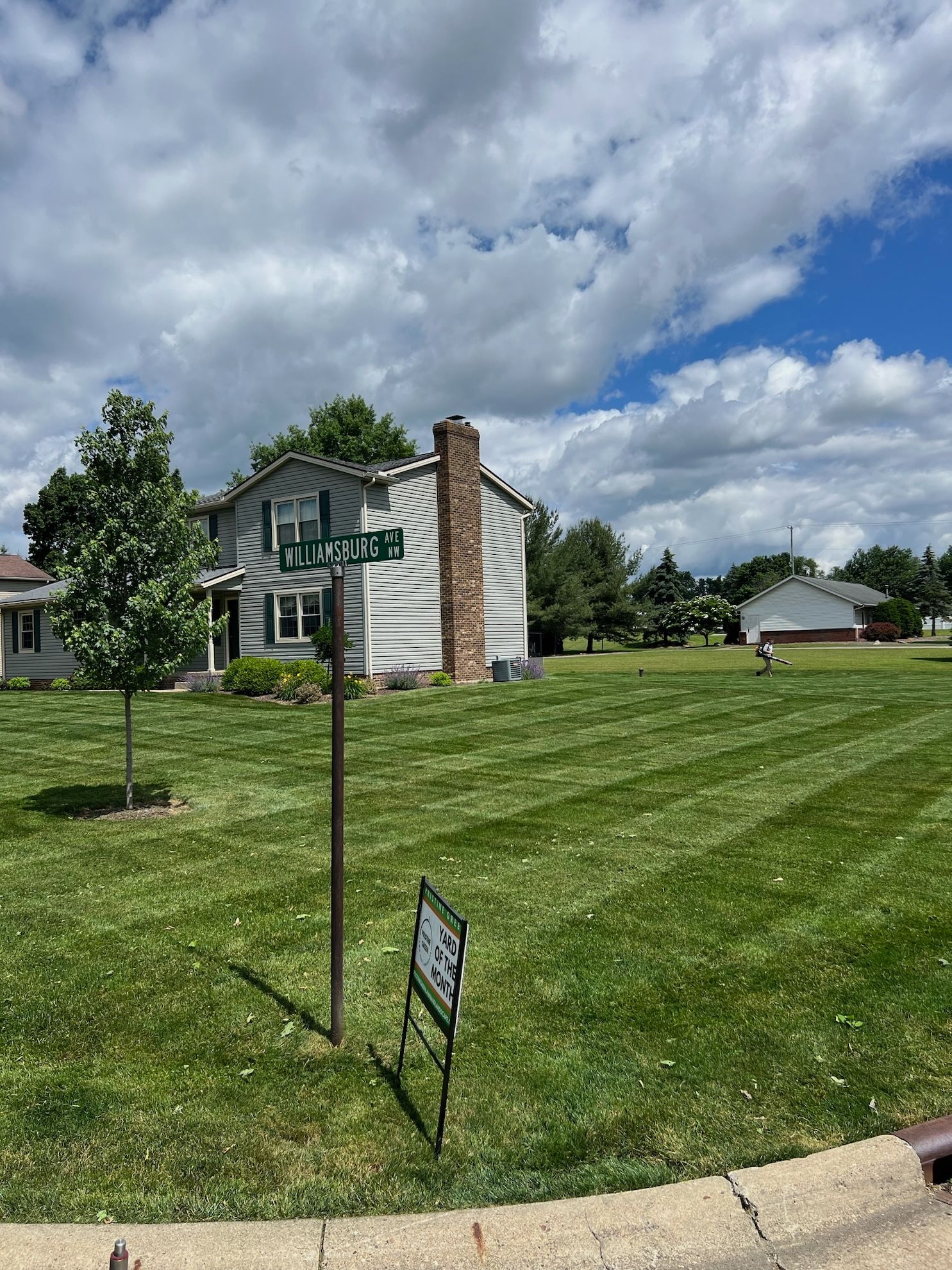A house with a lush green lawn in front of it.
