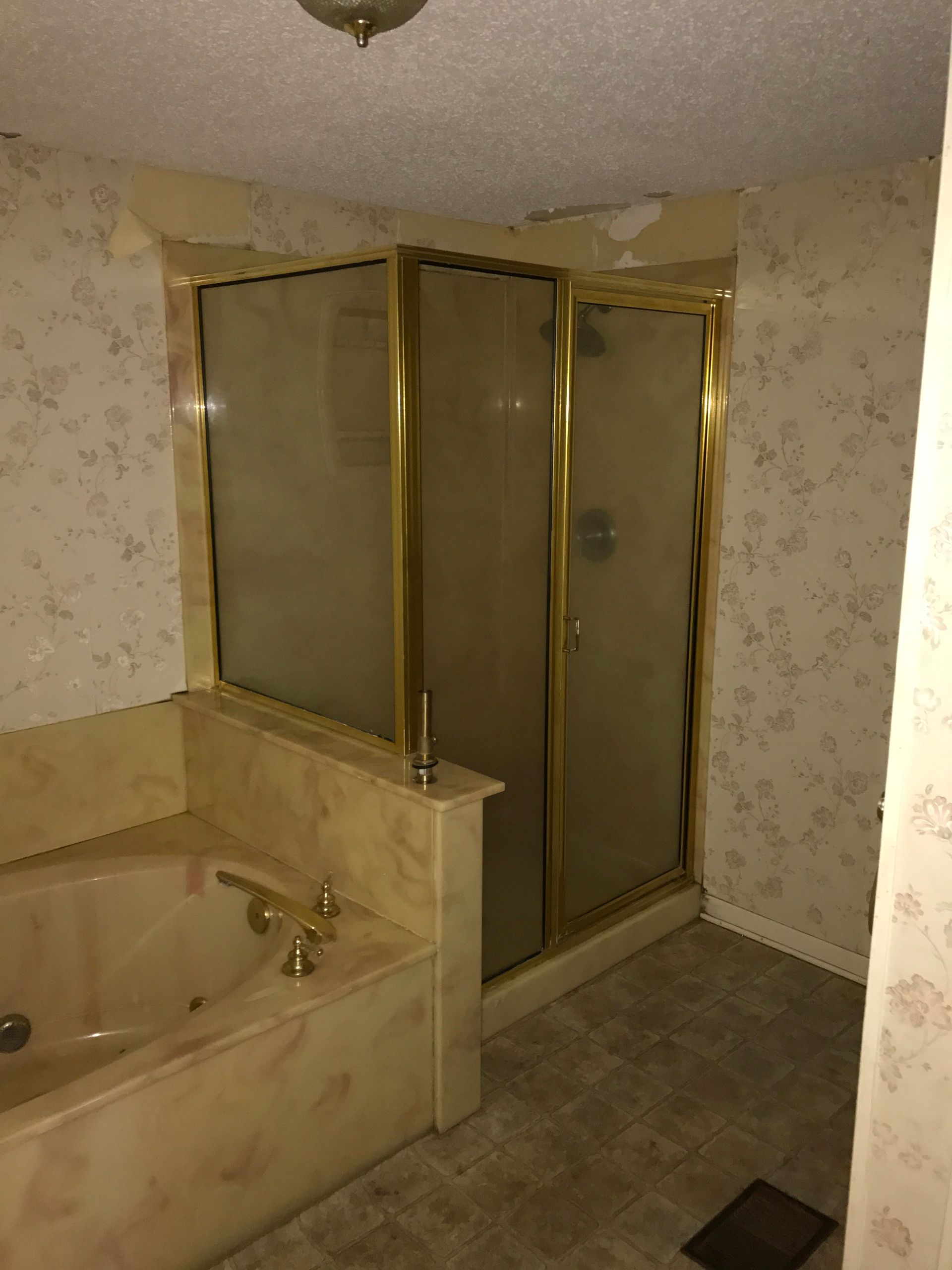 A bathroom with a bathtub and a walk in shower.