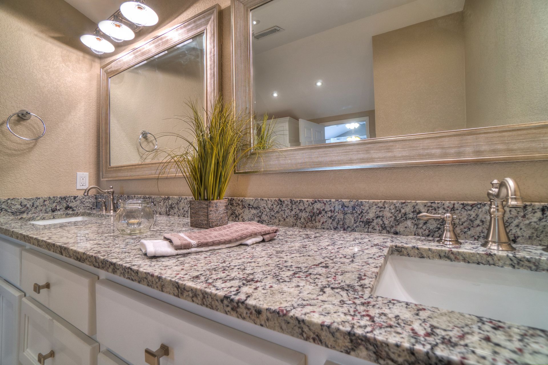 A bathroom with two sinks and a large mirror