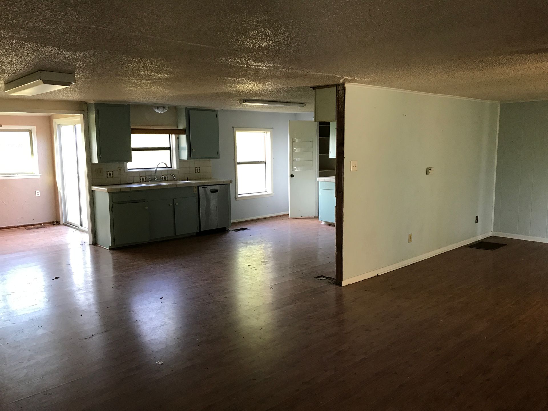 An empty house with a kitchen and a living room