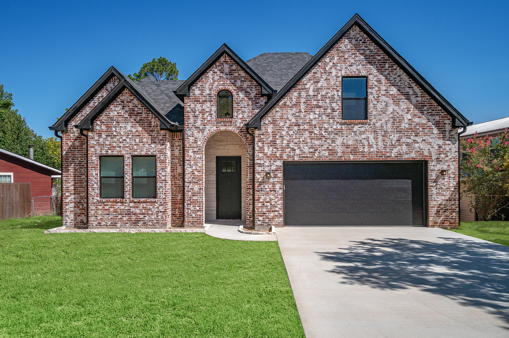A large brick house with a black garage door
