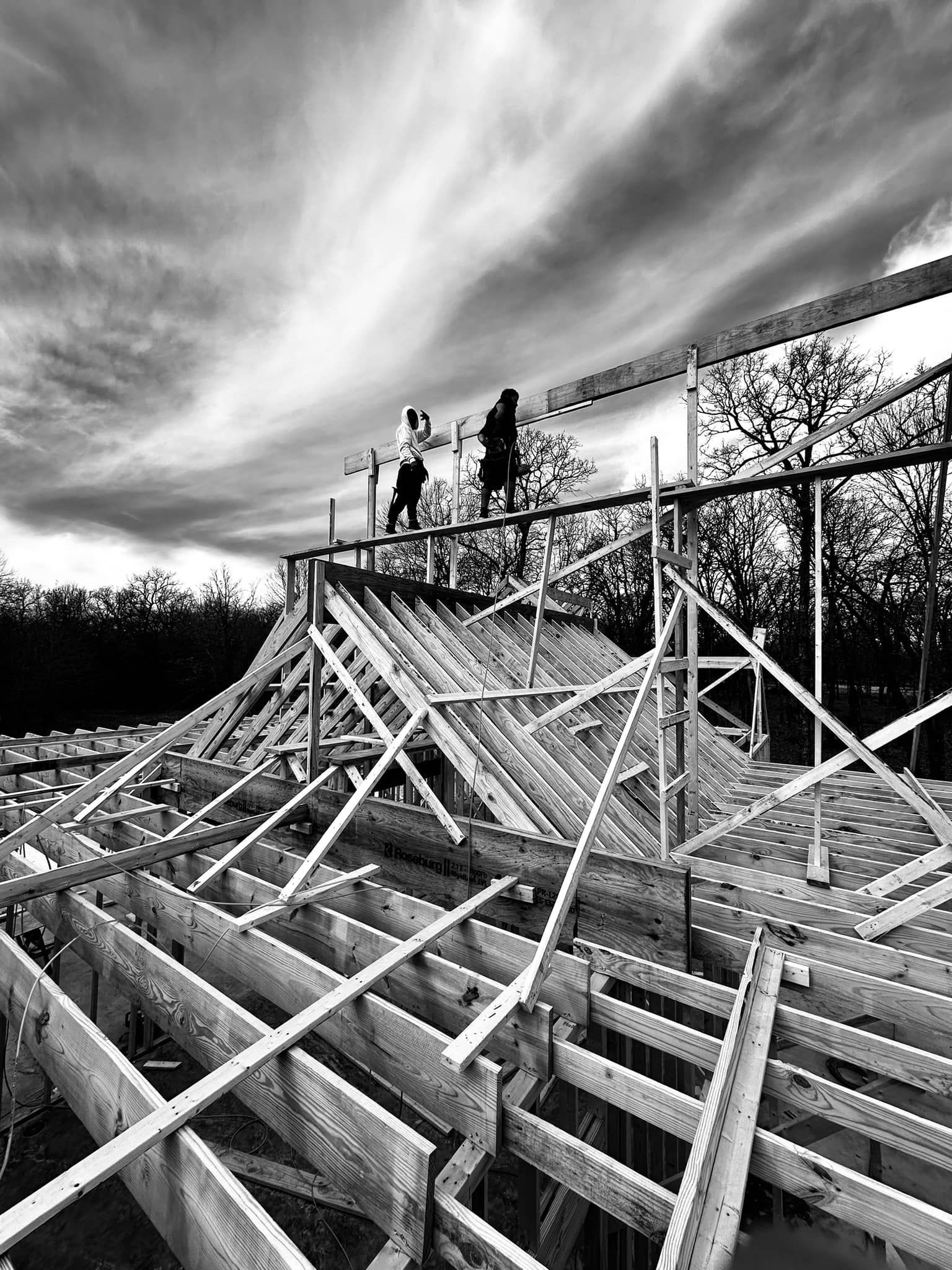 A black and white photo of a building under construction.