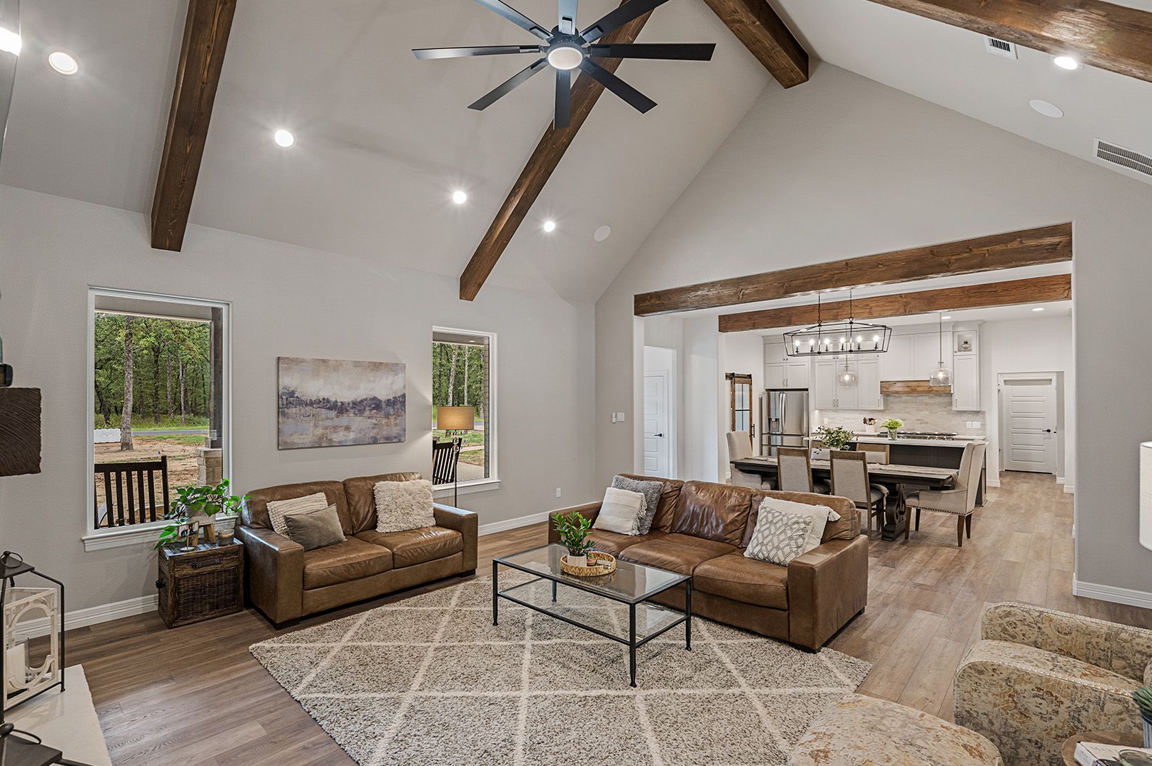 A living room filled with furniture and a ceiling fan.