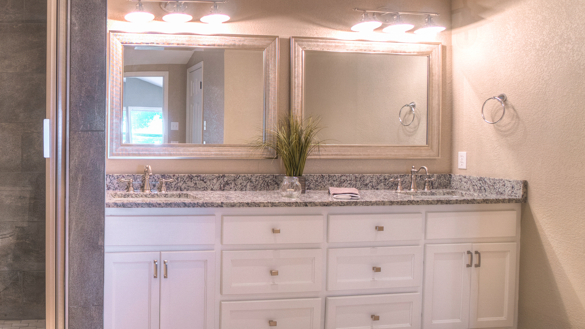 A bathroom with two sinks and two mirrors.