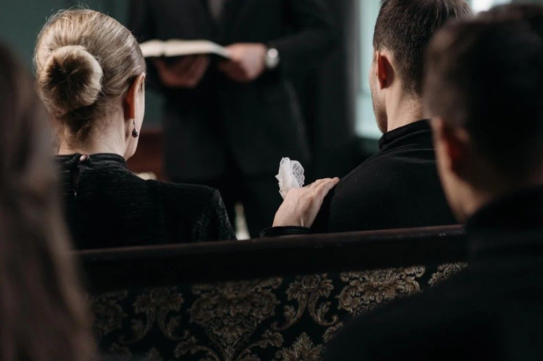 Family receiving compassionate guidance during a funeral service, reflecting the support families need most
