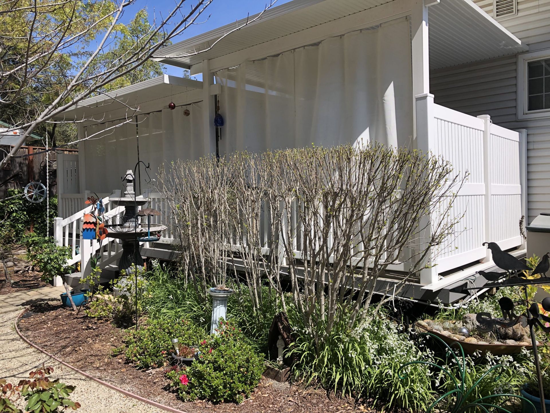 A white house with a white fence and a porch