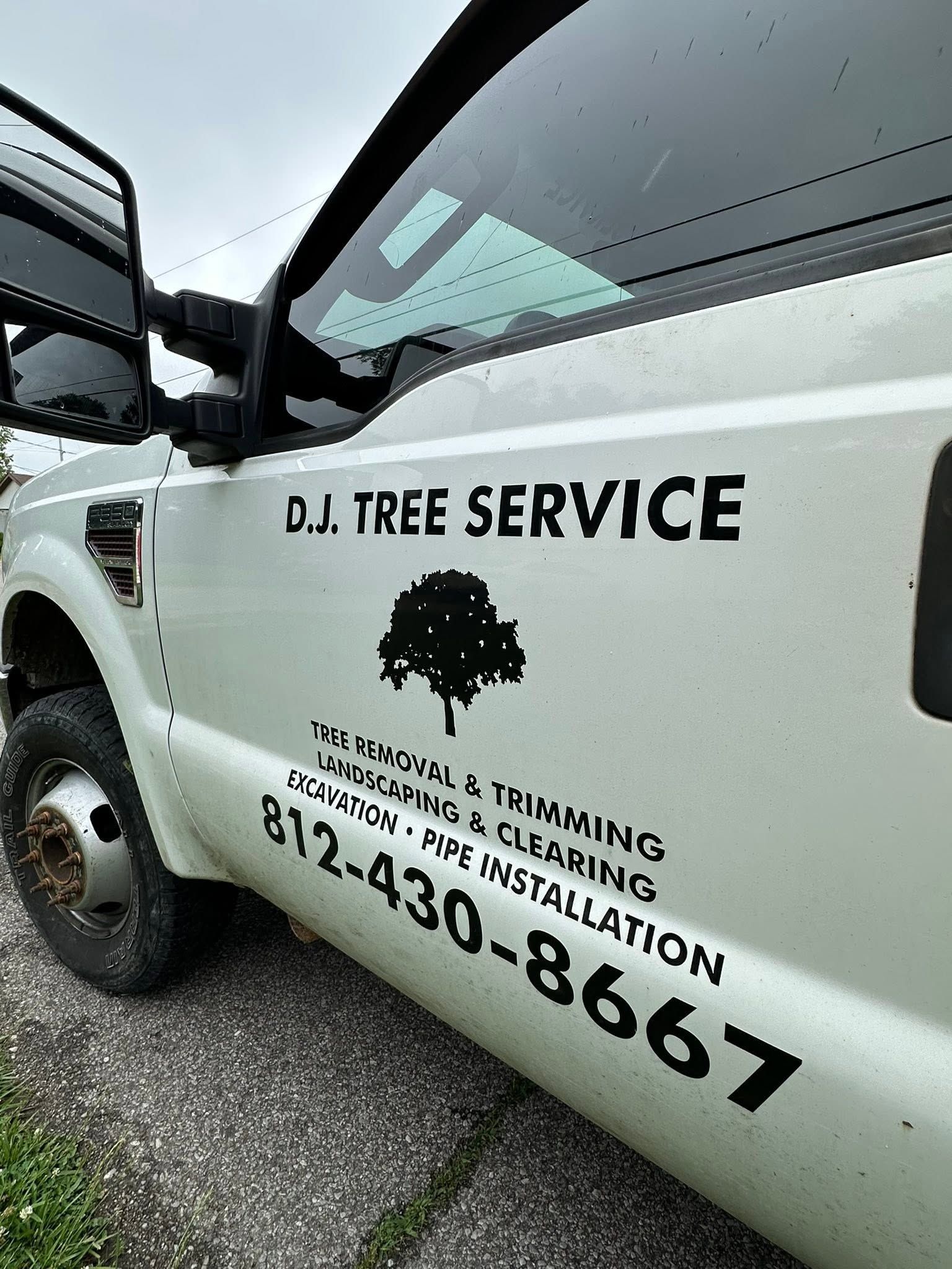 White D.J. Tree Service truck with company logo and phone number on the door