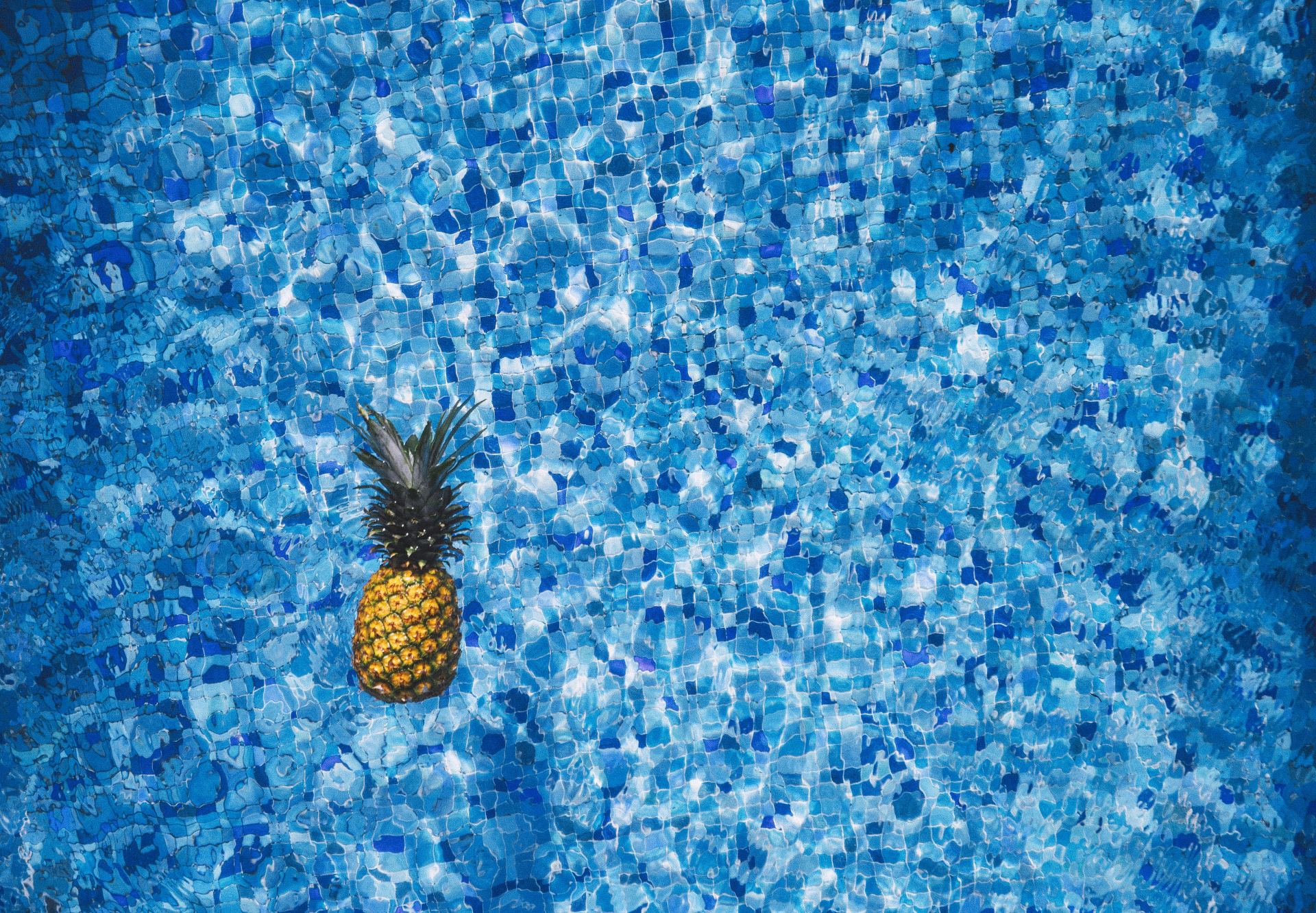 Pineapple Floating in Swimming Pool